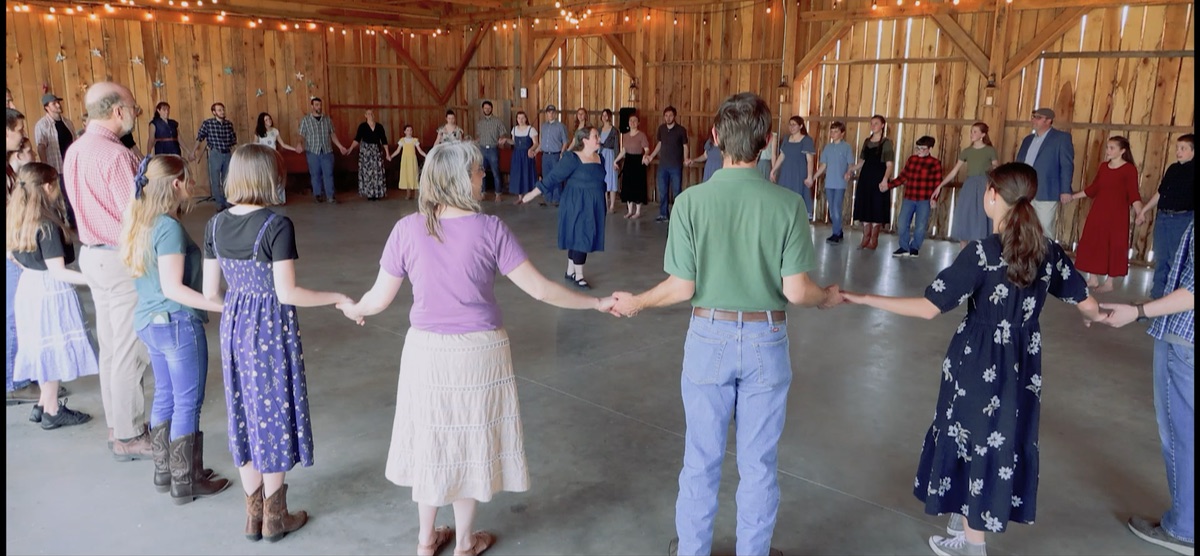 Families and friends forming a wide circle for the Circassian Circle